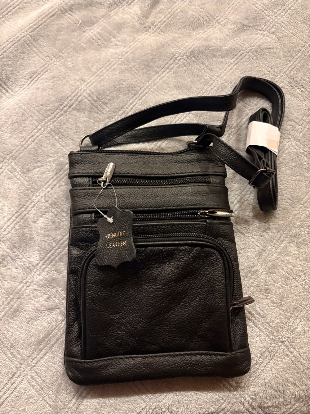 Genuine leather crossbody bag in black. Brand new with multi pockets